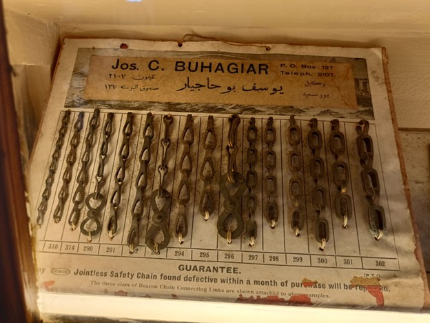 An exhibit featuring old metal chains in a museum, highlighting their design and historical context.
