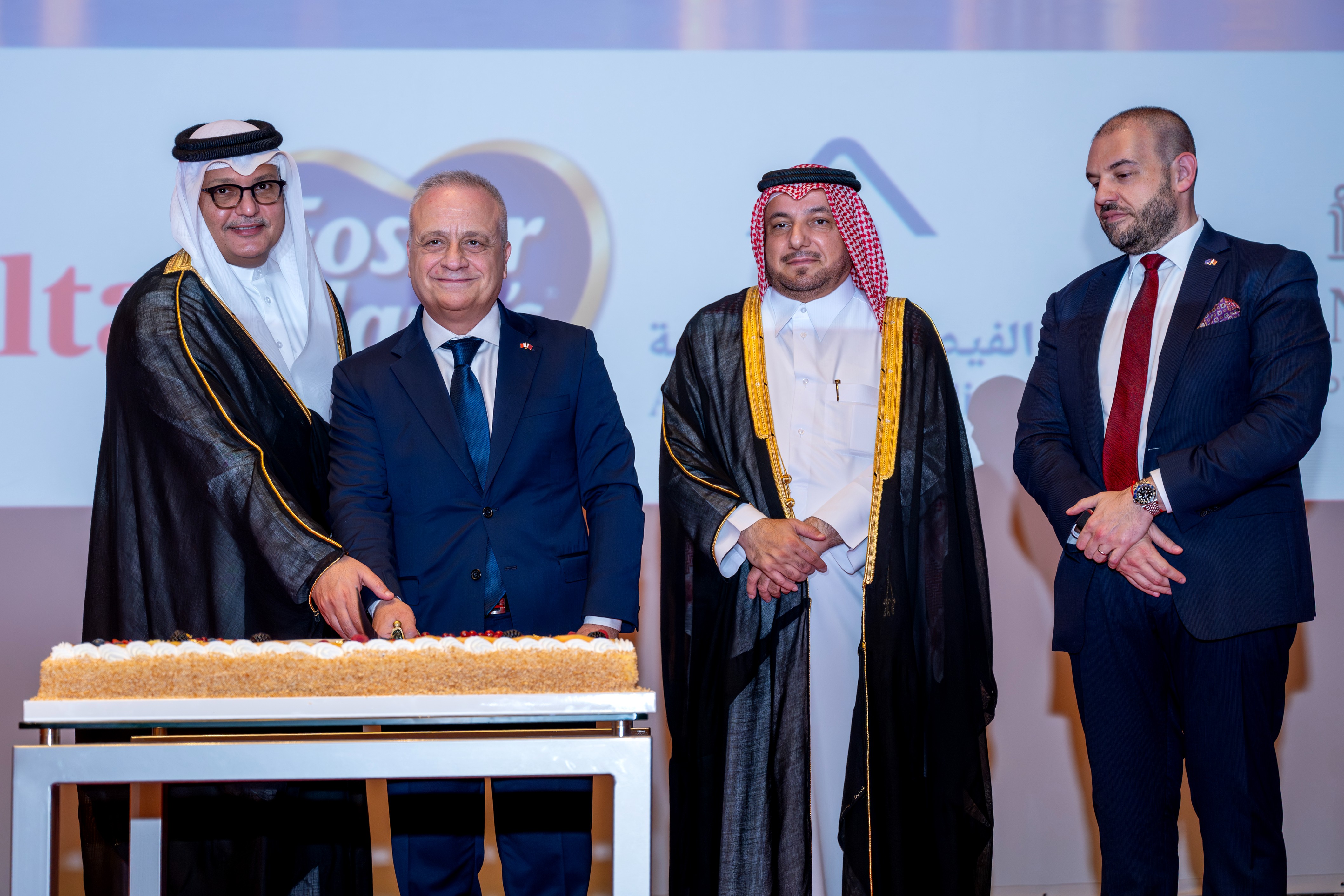 Traditional cake-cutting ceremony in the presence of distinguished guests.