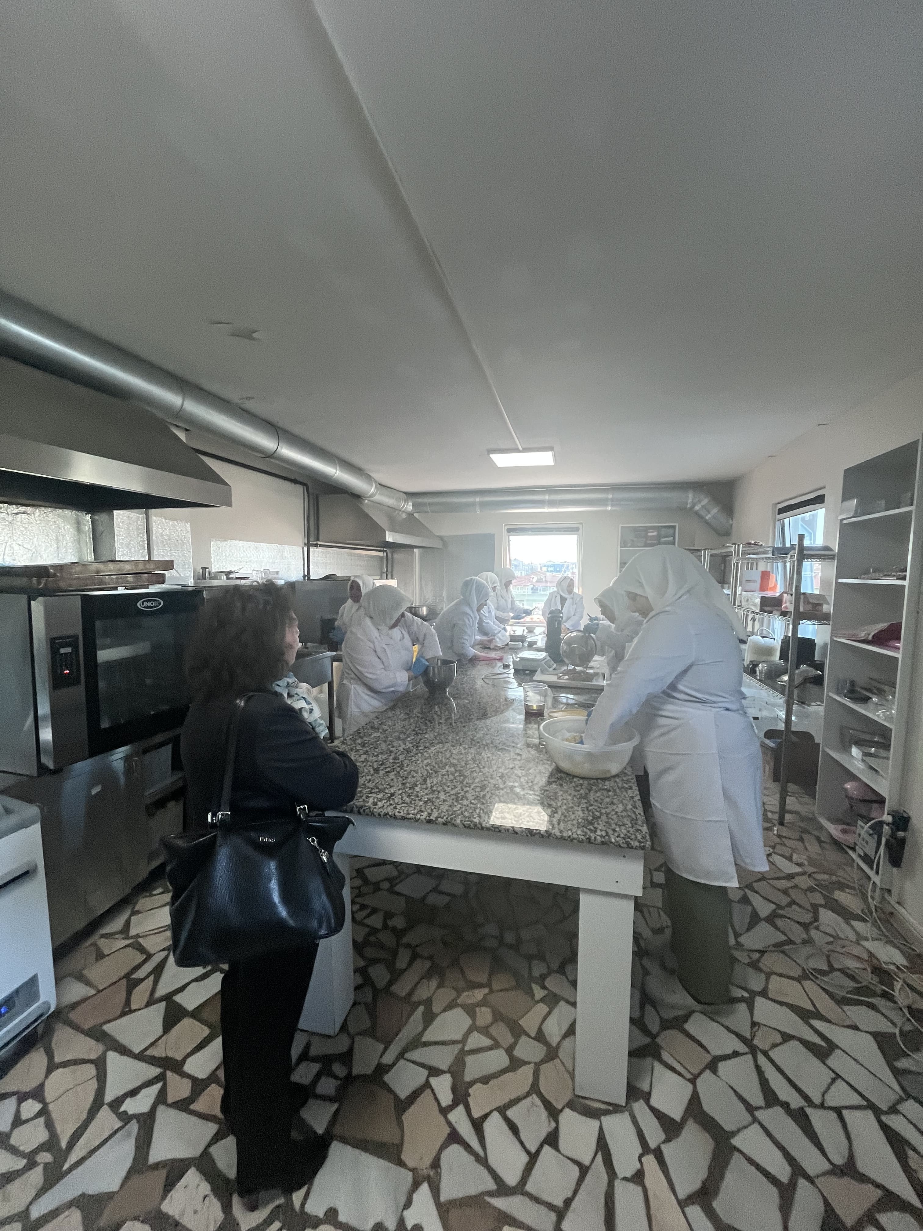 Ambassador Farrugia observing Migrant Women Working in the Hemdem Cooperative Kitchen