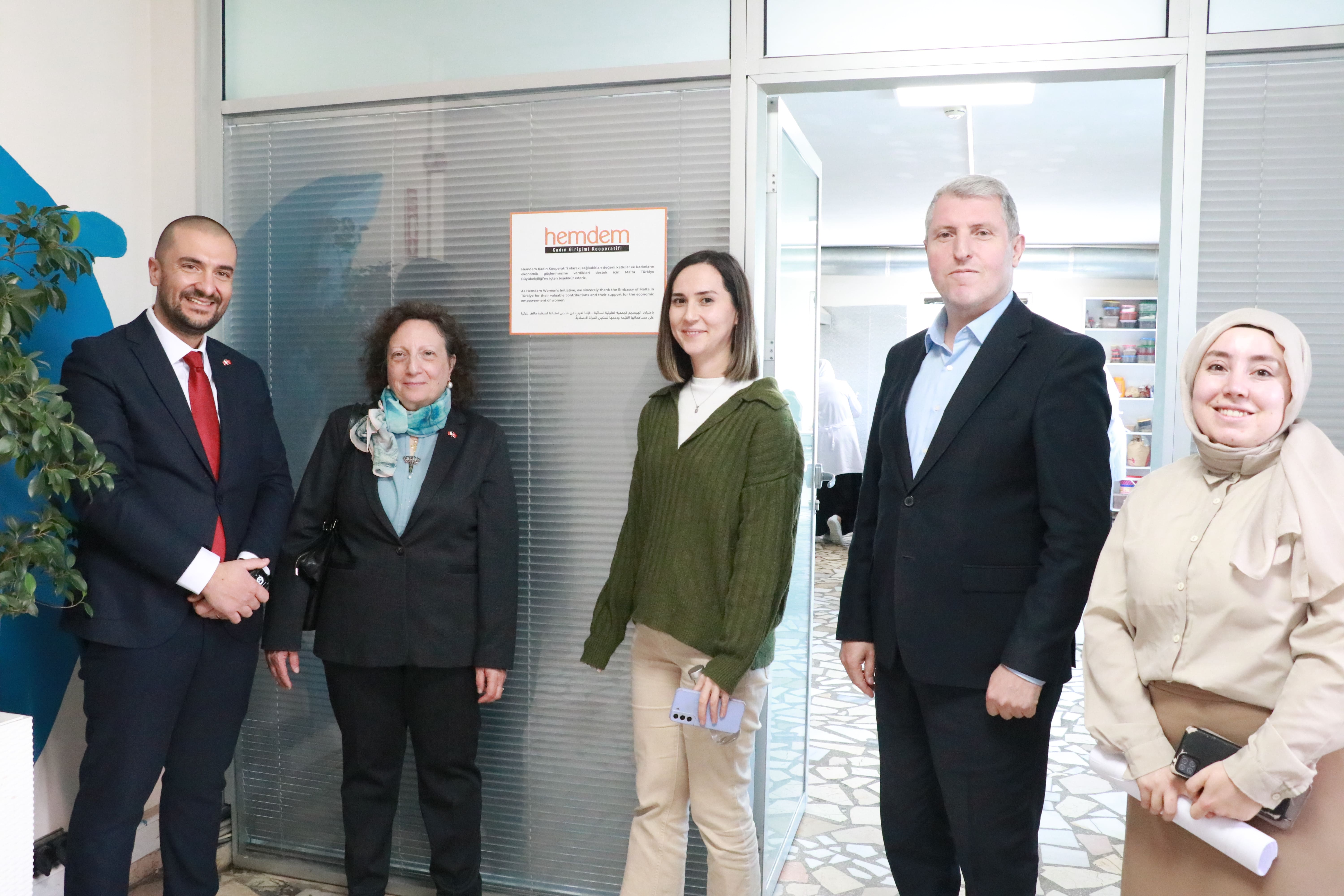 Ambassador Farrugia and Mr Calleja with Mülteciler Derneği staff observing a newly installed plaque noting Malta’s support to the Hemdem Cooperative