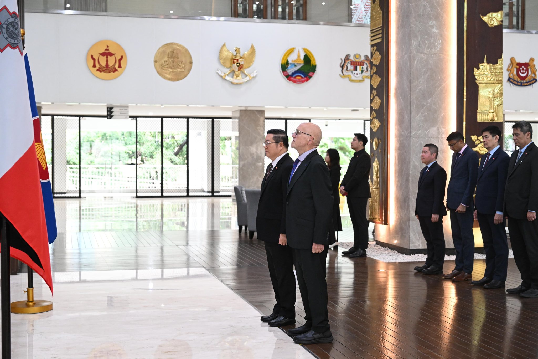 H.E. Clifford Borg Marks and H.E. Dr Kao Kim Hourn stand for the playing of the national anthems during the official ceremony at the ASEAN Secretariat.
